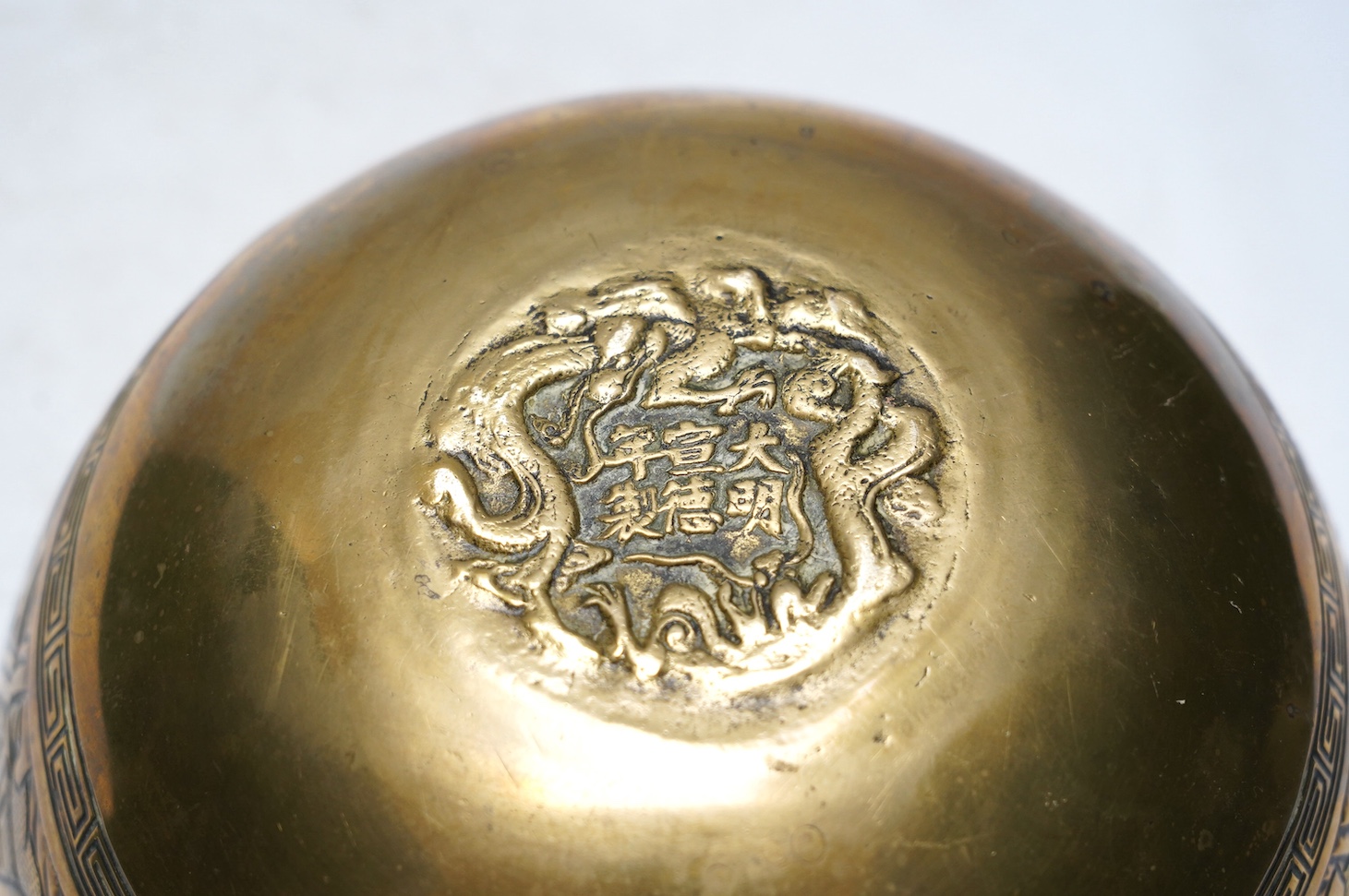 A Chinese bronze censer and cover, a Chinese bronze bowl and an Indian bronze seated deity, tallest 19cm high. Condition - fair some general scuffs and wear, the figure has a chip